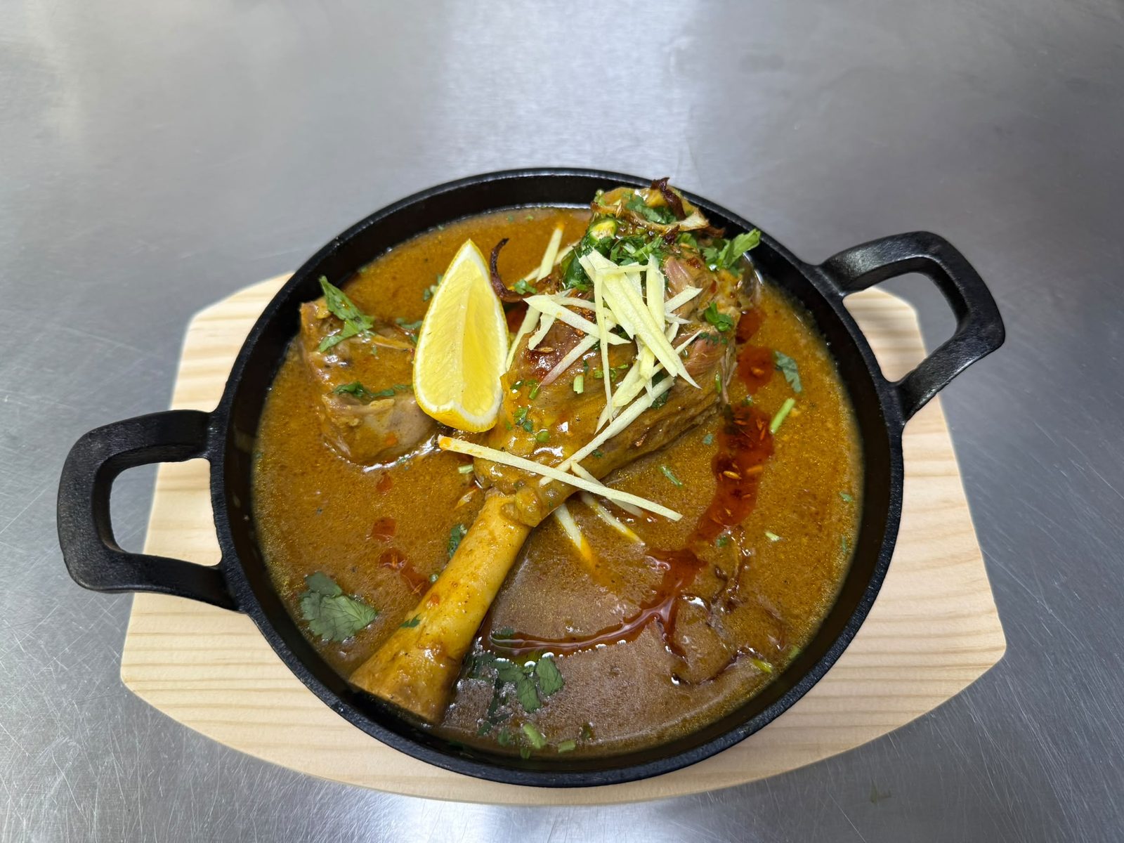Lamb shank nihari with marrow, lime and ginger, served whole in a cast-iron karahi